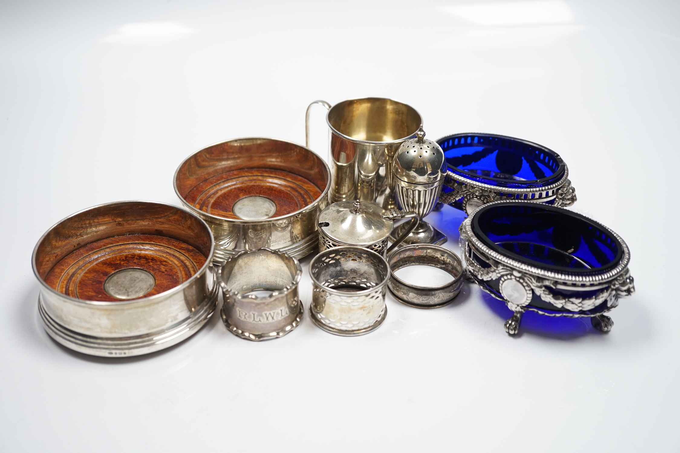 Sundry small silver wares including a pair of modern wine coasters, purse, mug, jug, napkin rings, etc, three plated salts and twelve sterling handled table knives and twelve dessert knives.